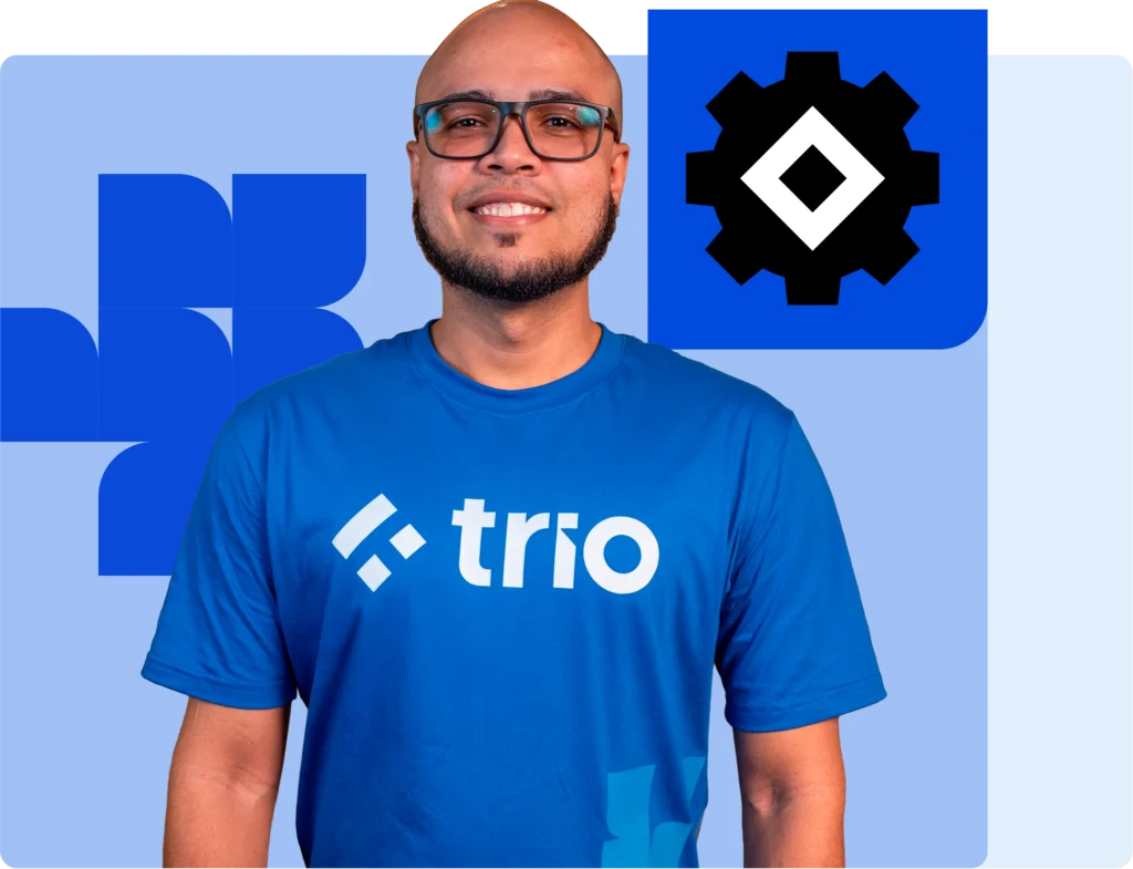 Smiling product engineer in Trio blue t-shirt with gear icon representing software product engineering services