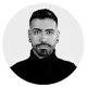 Stylish black and white headshot of a male professional with a modern look.