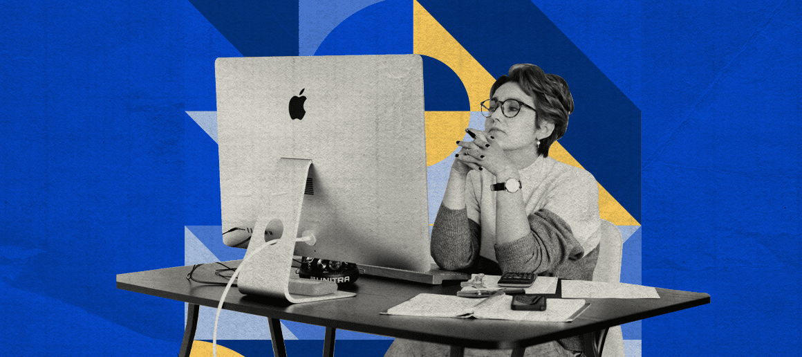 A monochromatic image of a person sitting at a desk with an iMac, hands clasped together in thought, amidst papers and a camera, against a backdrop of geometric shapes.