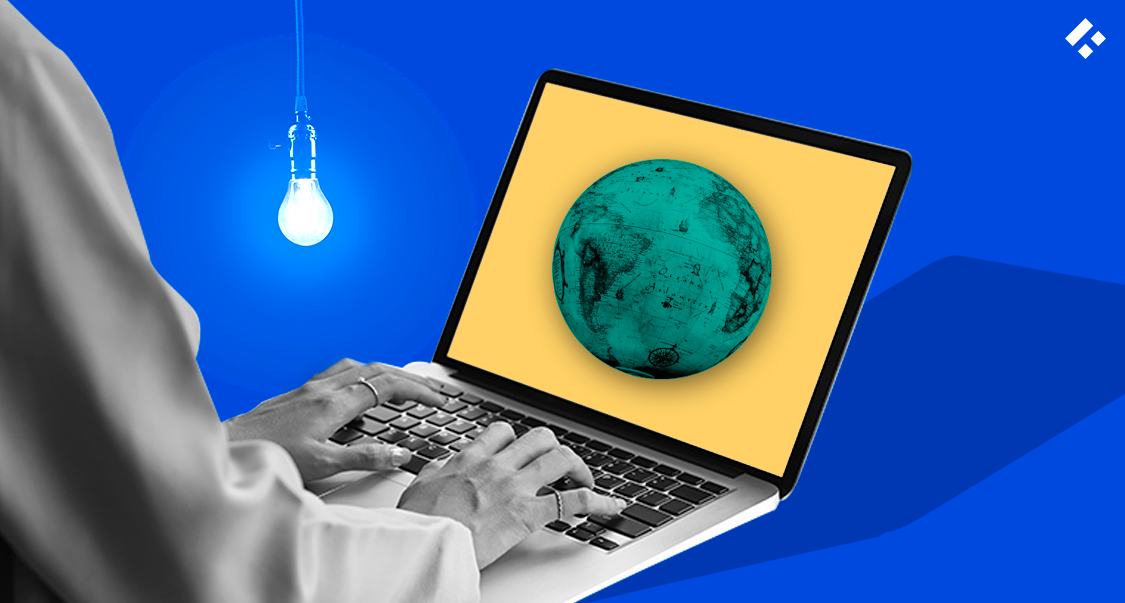 Person Typing on Laptop with a Globe on Screen