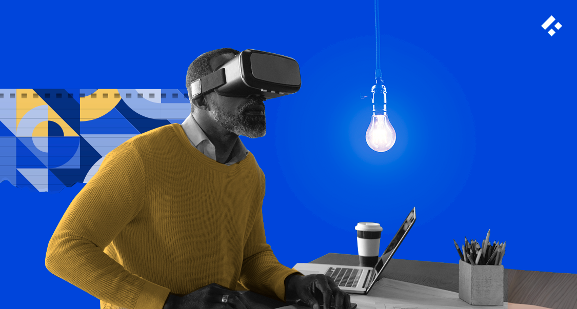 A man wearing a VR headset at a desk, with a glowing lightbulb representing innovation in the background.