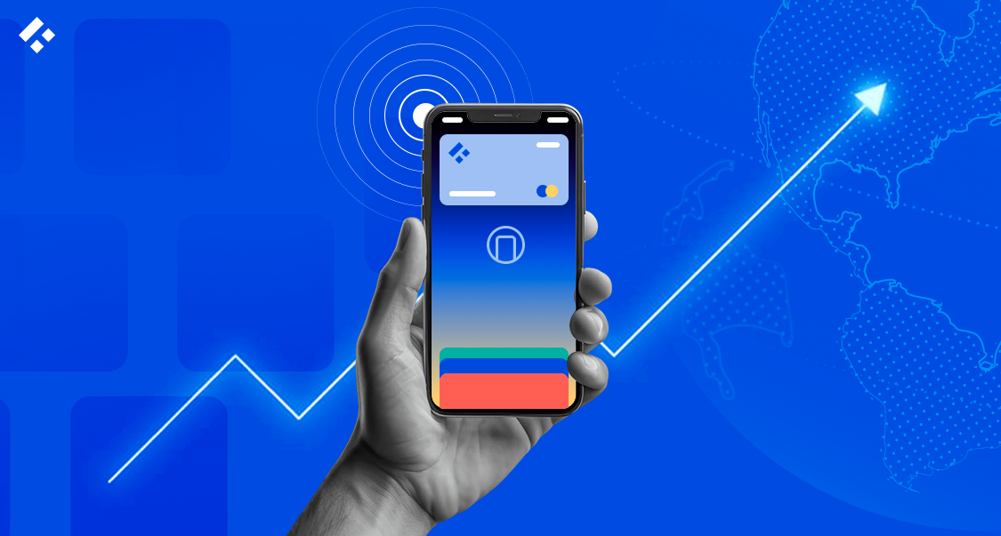 Hand holding a smartphone with digital wallet and upward growth arrow over a world map background.