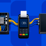 Hand wiring a motherboard to a payment terminal and branded hardware box, representing the build vs. buy decision for a payment orchestration platform
